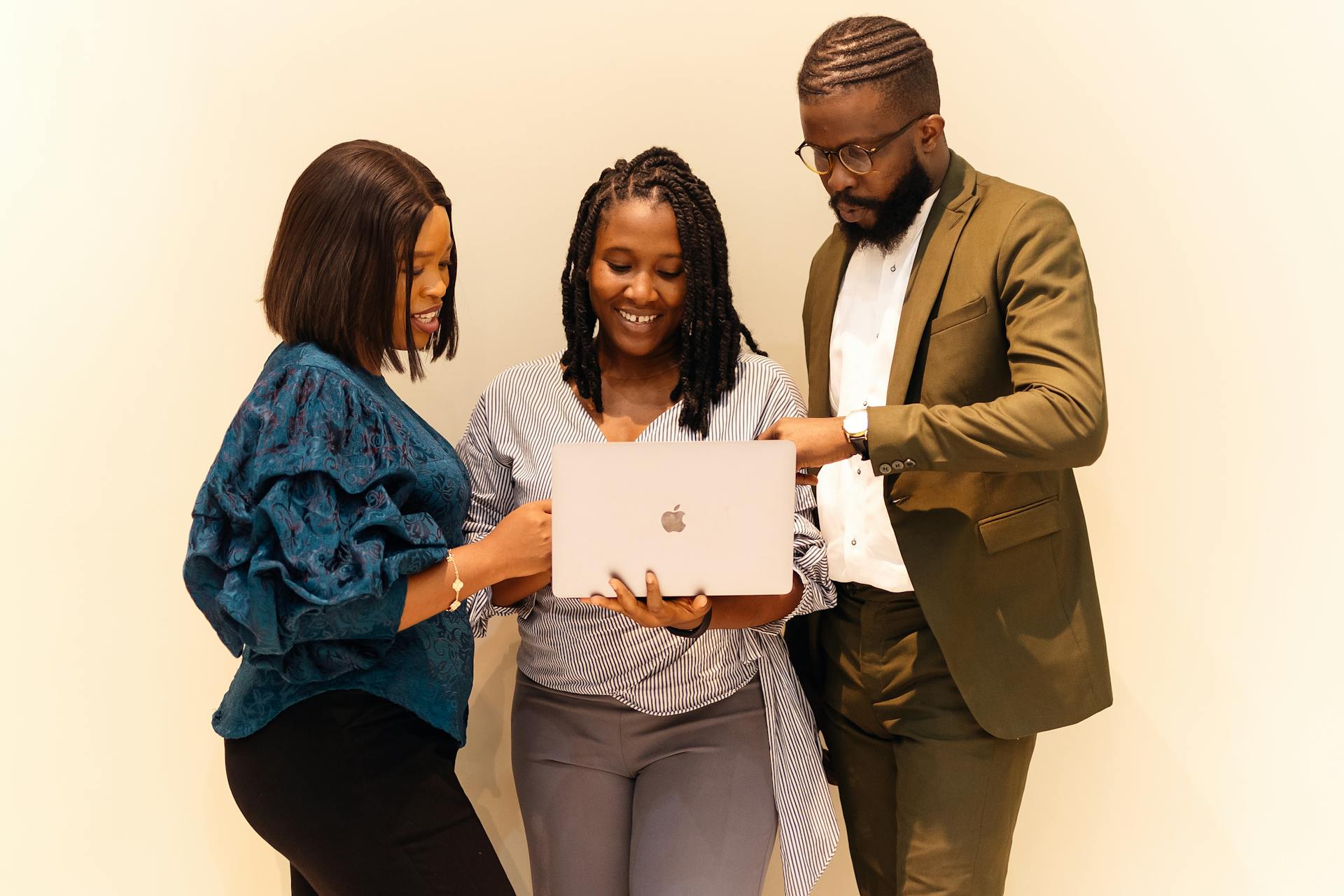 Group of black people looking at a laptop